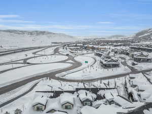 Snowy aerial view featuring a mountain view