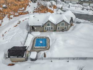 Snowy aerial view featuring view of pool