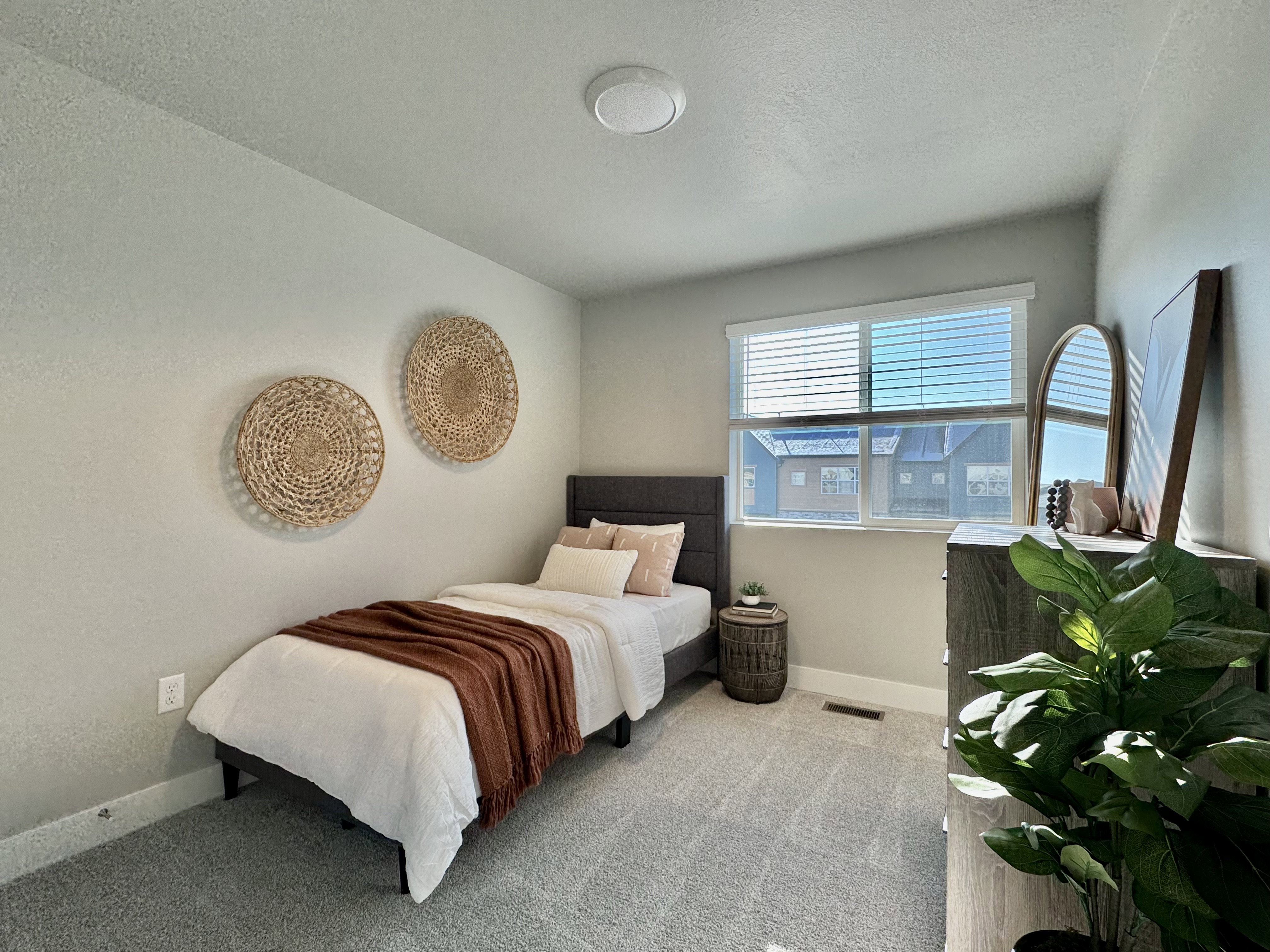 Carpeted bedroom with baseboards and a textured ceiling