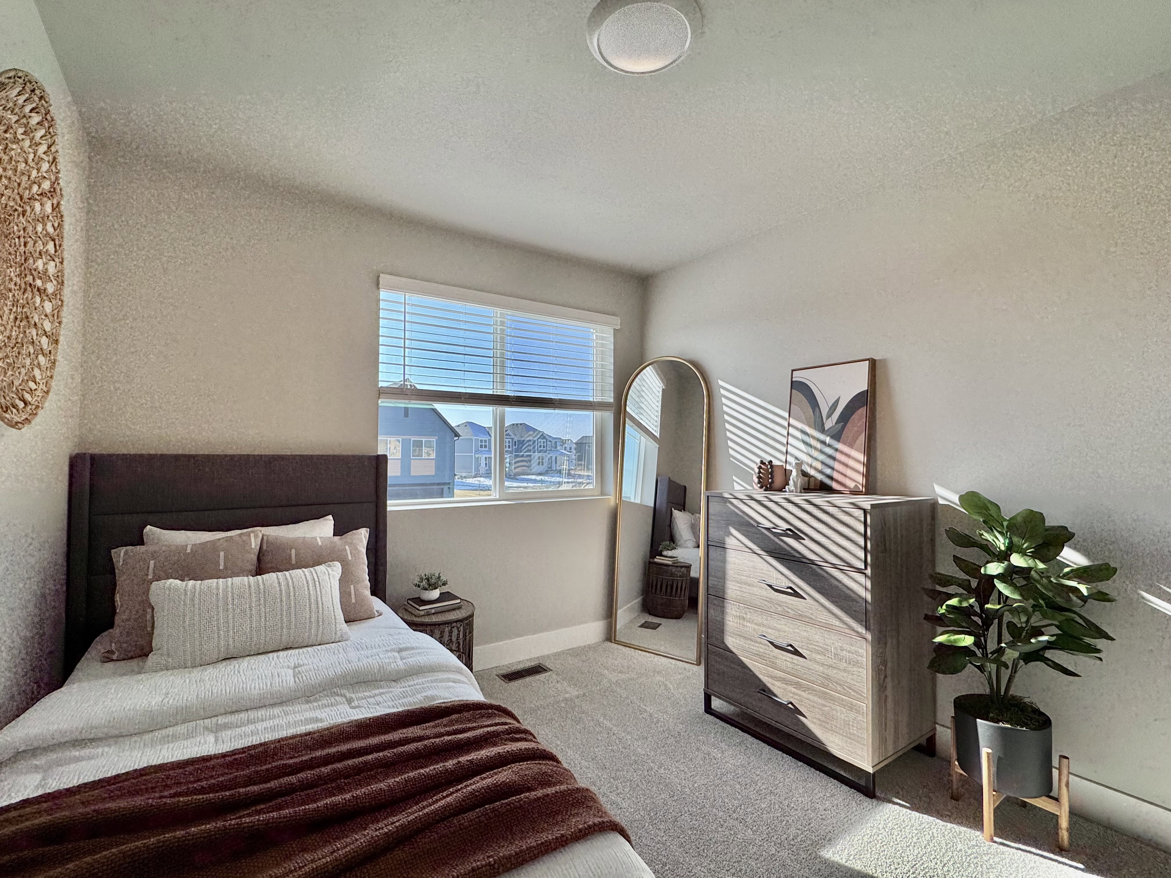 Bedroom with a textured wall, carpet flooring, and a textured ceiling