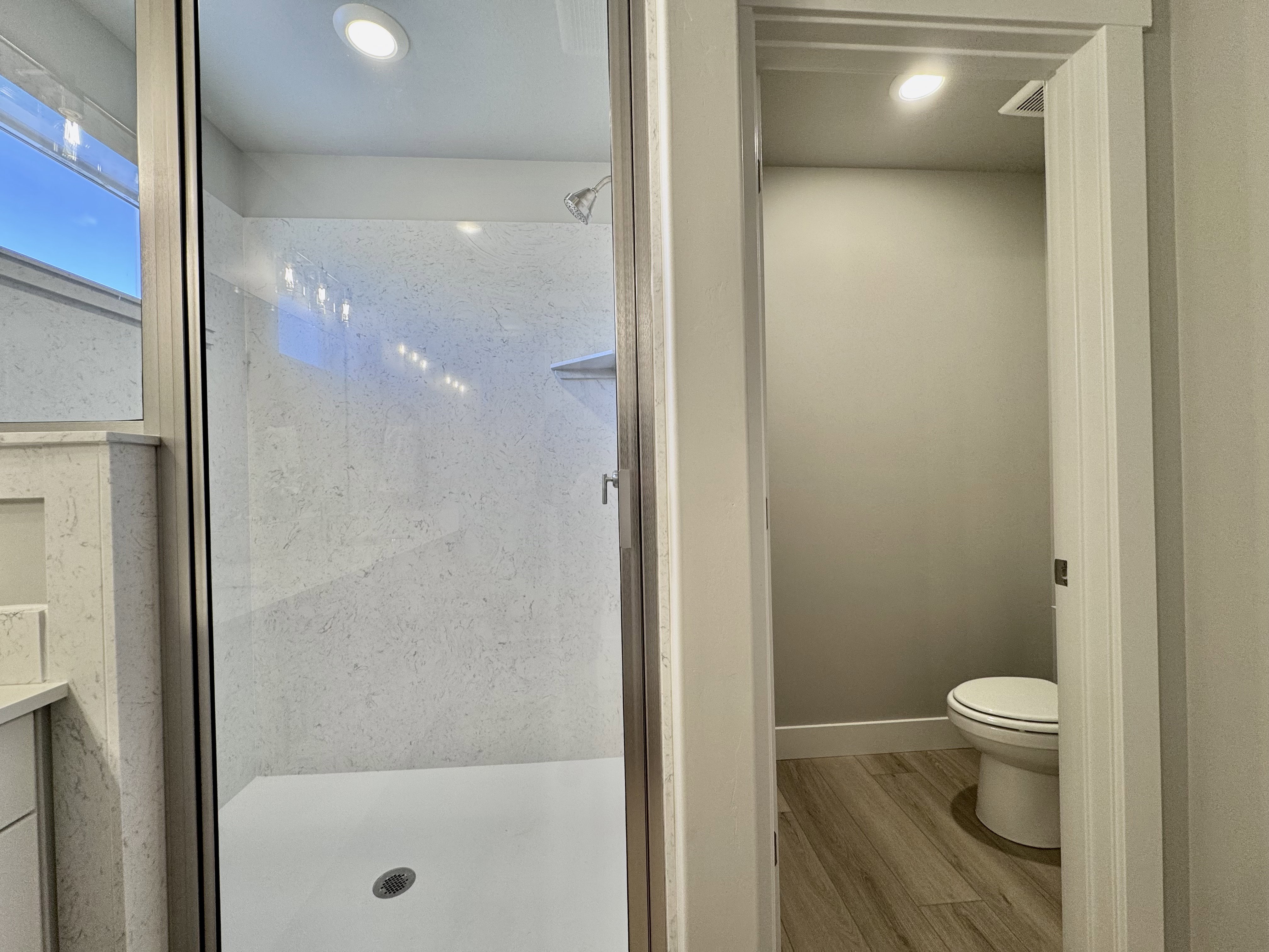 Bathroom with a stall shower, light wood-type flooring, and recessed lighting