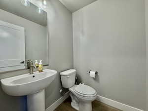 Bathroom featuring baseboards and wood finished floors