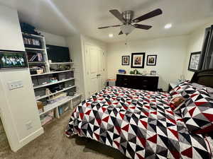Bedroom with light carpet, recessed lighting, and a ceiling fan