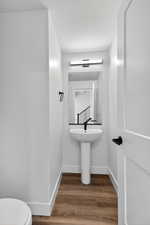 Bathroom featuring wood finished floors and a textured ceiling