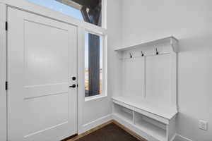 Mudroom with wood finished floors and baseboards
