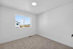 Carpeted empty room with baseboards