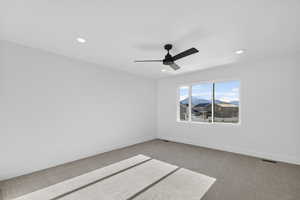 Carpeted spare room with ceiling fan and recessed lighting