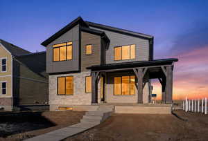 View of front of property with stone siding and covered porch