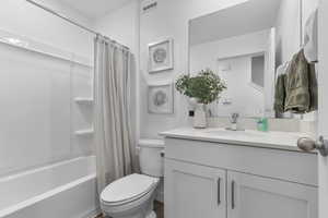 Full bathroom with shower / bathtub combination with curtain and vanity