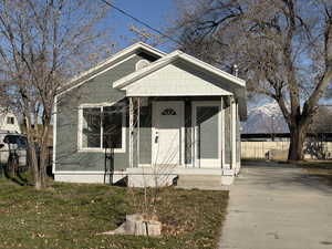 View of front of property with covered porch and driveway