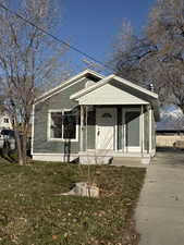 Bungalow-style house featuring a porch and a front yard
