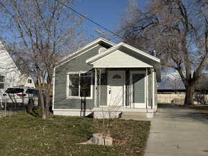 View of front of property featuring covered porch and concrete driveway
