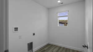 Laundry room featuring wood finished floors, hookup for a washing machine, and hookup for an electric dryer