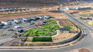 Aerial view of property and surrounding area featuring nearby suburban area