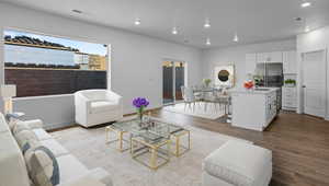 Living room with dark wood-style floors and recessed lighting