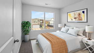 Bedroom featuring baseboards and carpet floors