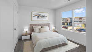 Bedroom featuring carpet flooring and baseboards