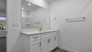 Bathroom with vanity and recessed lighting