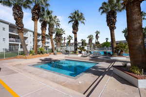 Community pool with a patio