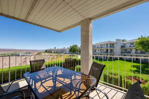 Balcony featuring outdoor dining area and a sunroom