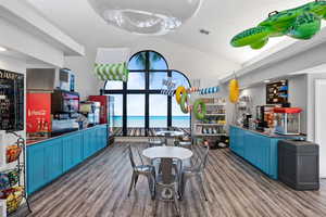 Dining space featuring dark wood-type flooring and high vaulted ceiling