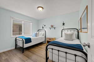 Bedroom featuring a textured ceiling and wood finished floors