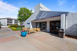 Rear view of house featuring stucco siding, a tile roof, and an outdoor hangout area