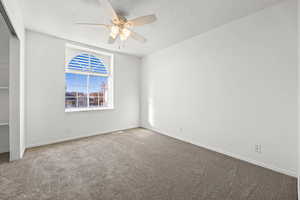 Unfurnished bedroom featuring new paint, new carpet, a ceiling fan, and a closet