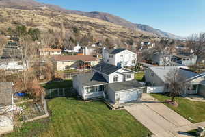 Aerial view of residential area featuring a mountainous background