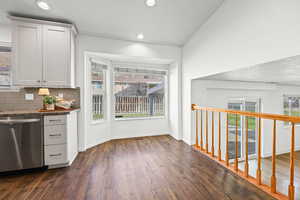 Kitchen with stainless steel dishwasher, backsplash, plenty of natural light, a textured ceiling, and recessed lighting