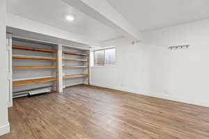 Below grade area featuring light wood-type flooring and baseboards