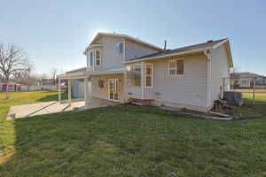 Back of property featuring large covered patio area