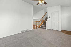 Empty room with carpet and ceiling fan