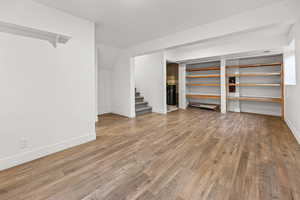 Below grade area with light wood-type flooring and stairway