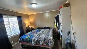 Bedroom featuring carpet flooring and crown molding