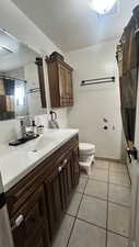 Bathroom with a shower with curtain, vanity, and light tile patterned floors