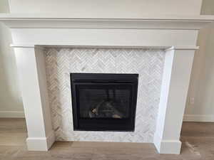 Detailed view of a fireplace and wood finished floors