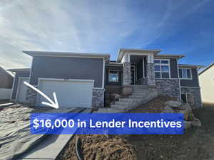 Prairie-style home featuring stone siding and an attached garage
