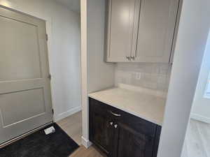 Kitchen with light stone counters and light wood finished floors