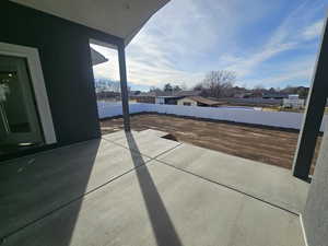 Fenced backyard featuring a residential view and a patio