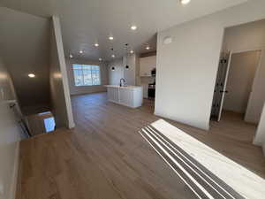 Unfurnished living room featuring recessed lighting and light wood-style floors