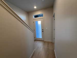 Entrance foyer featuring baseboards and light wood-style flooring