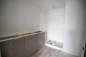 Full bath with light wood-type flooring and a shower