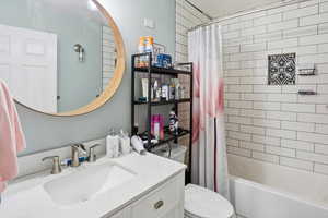 Bathroom featuring vanity and shower / tub combo