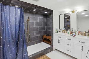 Bathroom with a stall shower and double vanity