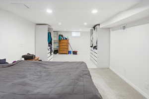 Bedroom with light carpet and recessed lighting