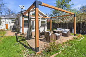 Fenced backyard featuring an outdoor lounge area and a patio area