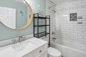 Full bath featuring vanity and bathing tub / shower combination
