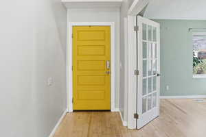 Doorway featuring hardwood / wood-style floors and baseboards