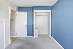Unfurnished bedroom with carpet floors and a closet